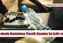 Araba koltuğunda unutulmuş plastik su şişesi, sıcak bir günde güneş ışığına maruz kalmış durumda